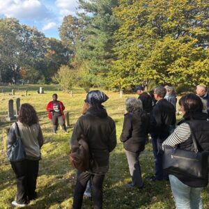 A tour guide leads a tour through a historic cemetery
