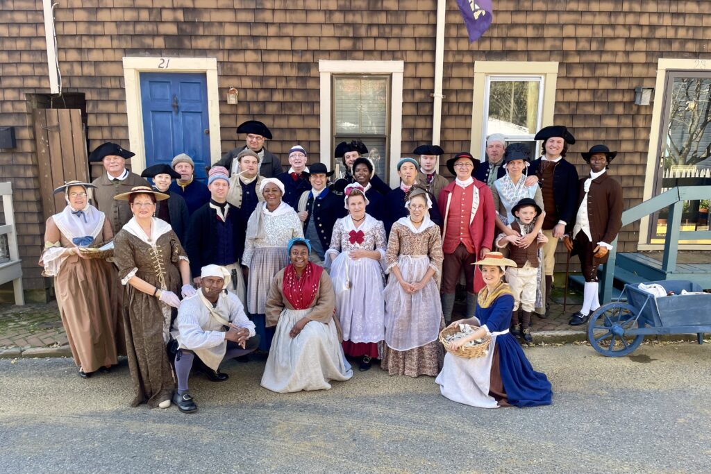Group of living historians dressed in 18th-century attire portraying Annapolis residents during the Peggy Stewart 250th anniversary celebration, part of Historic Annapolis’s living history program.