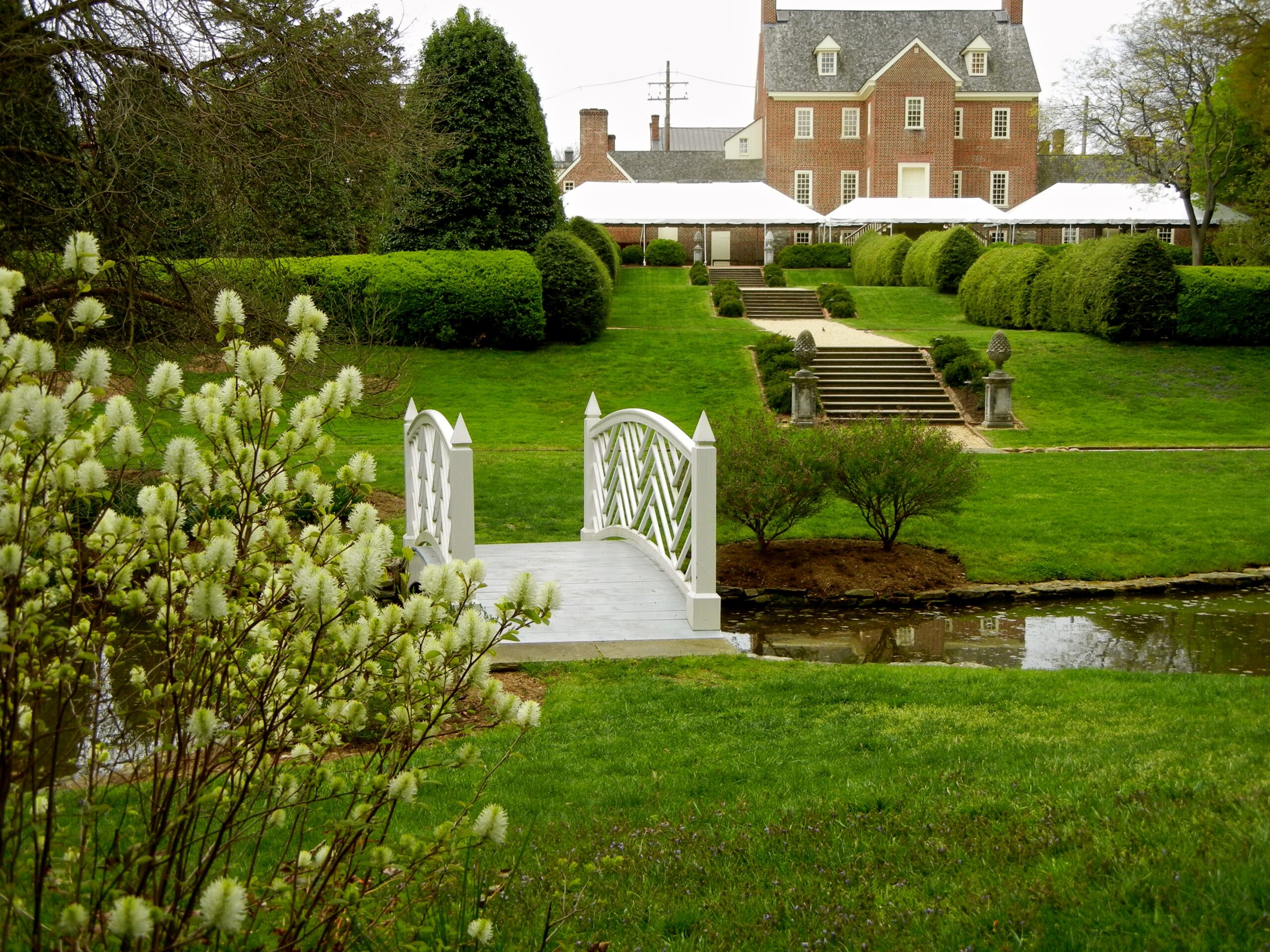 The white lattice bridge and formal gardens at the William Paca House, offering a peaceful escape in historic Annapolis.