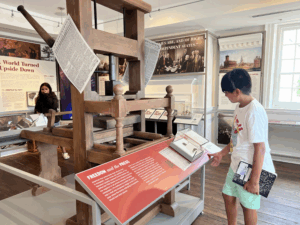 Visitors exploring the printing and publishing exhibit at the Museum of Historic Annapolis, part of Annapolis: An American Story.
