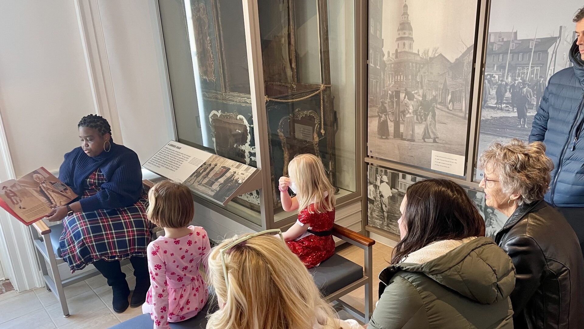 A volunteer reads a story to children