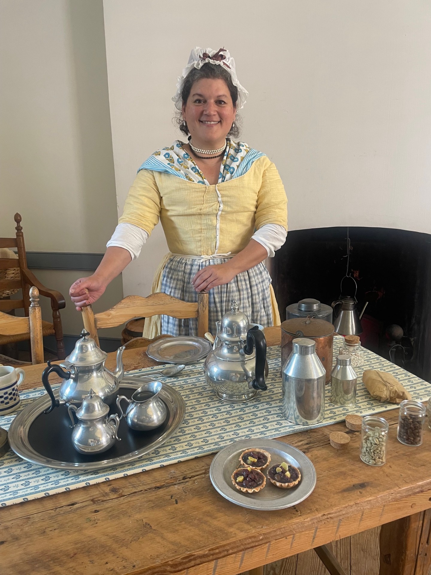 A living historian displaying a colonial-era coffee service