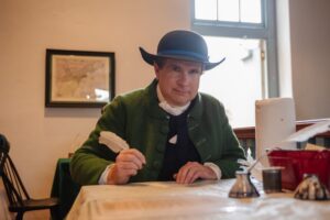 Living historian Sean Lowman dressed as a colonial tailor