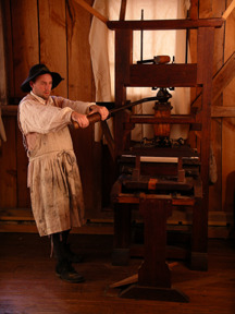 A reenactor portraying a colonial-era printer