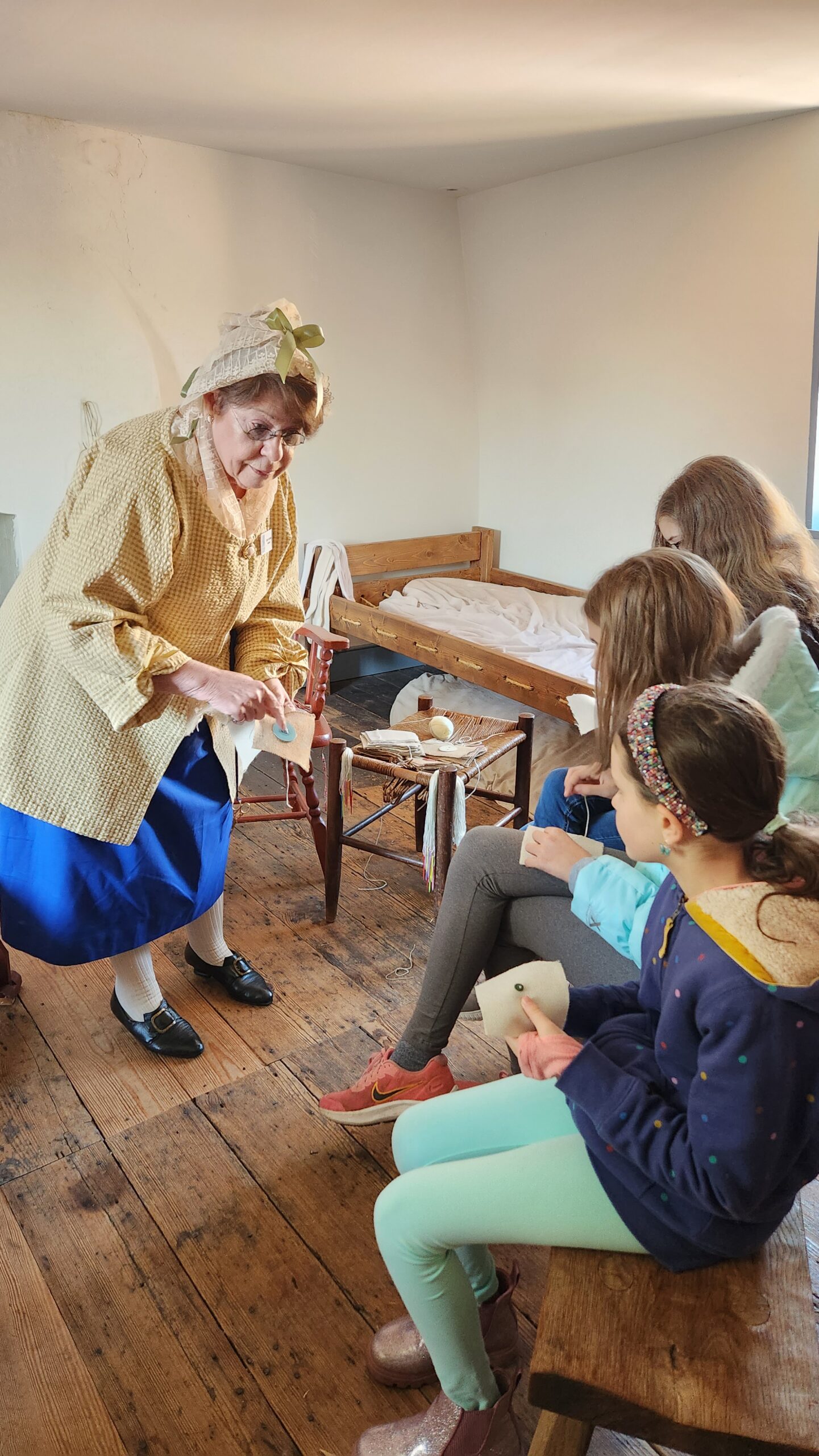 Children doing an activity led by a historic reenactor