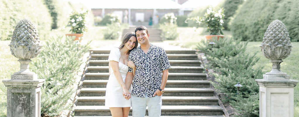 Two people standing in a colonial garden