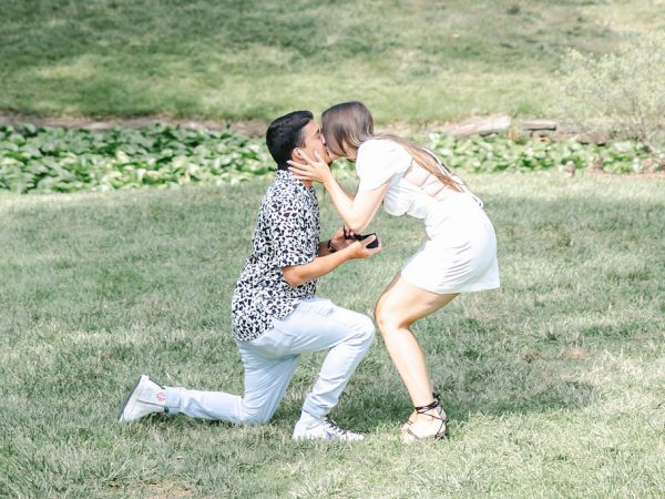 A couple celebrating a proposal moment in the garden at the William Paca House, a romantic engagement and wedding venue in Annapolis.