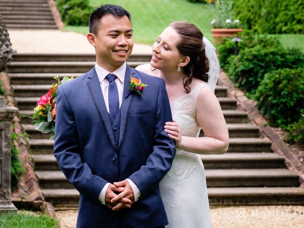 Bride and groom sharing a joyful moment on the garden steps at the William Paca House, a historic wedding venue in downtown Annapolis.
