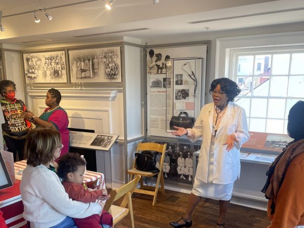 Museum educator leading a guided tour at the Museum of Historic Annapolis, sharing stories from Annapolis’s rich history.